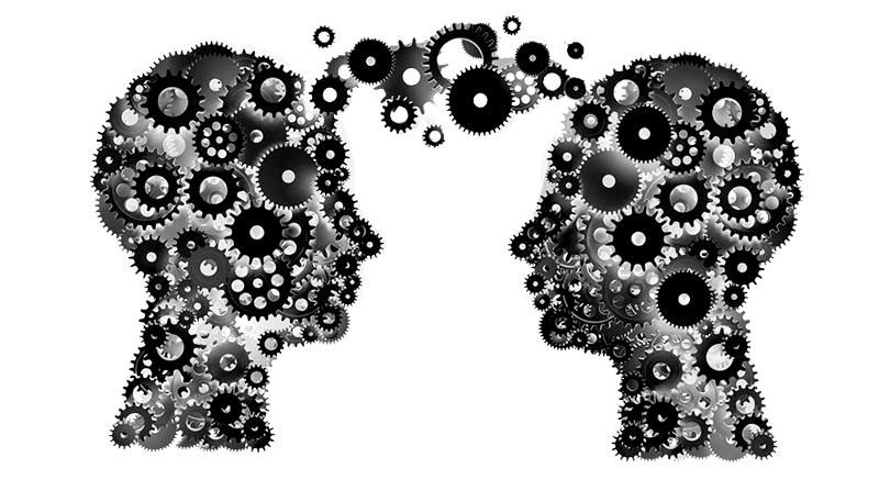 Two profiles made of interlocking gears, connecting minds